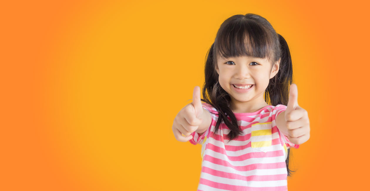 Girl standing with her thumbs up